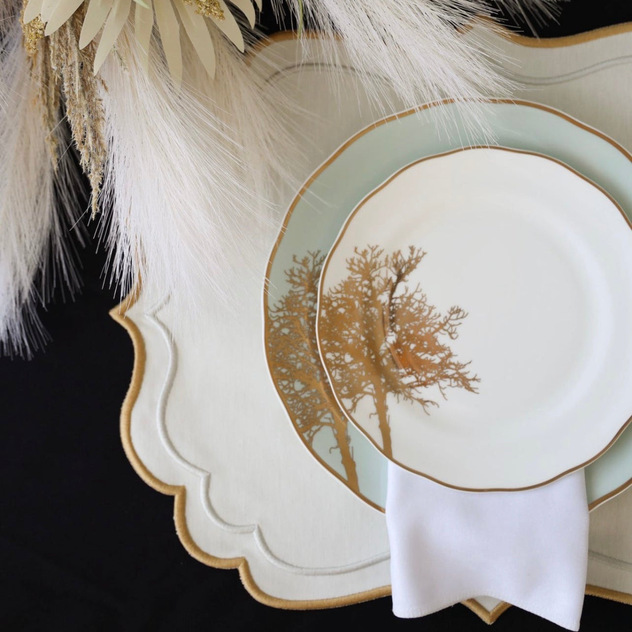 Flatlay view of the Arista Cream Fabric Placemat with embroidered detailing