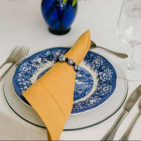 Blue Willow porcelain style beaded napkin ring front view with classic blue and white pattern.