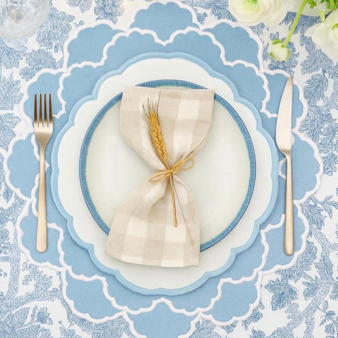 Spring table setting featuring the elegant Cressida Scalloped Blue placemat for seasonal dining