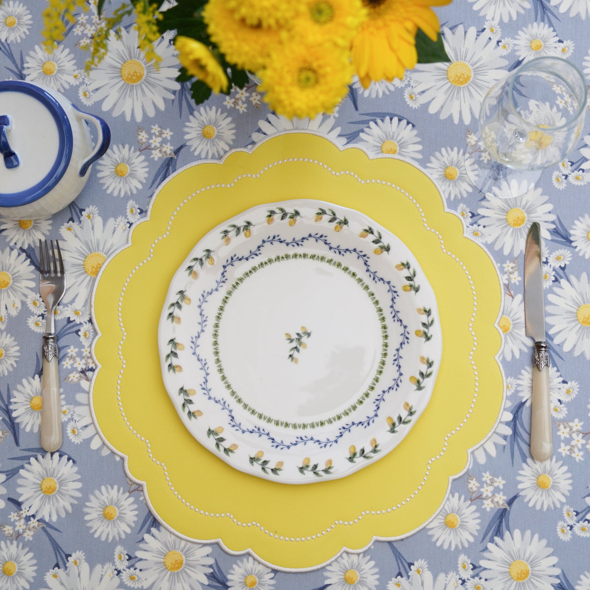 Stylish tabletop setting featuring scalloped-edge faux leather placemat