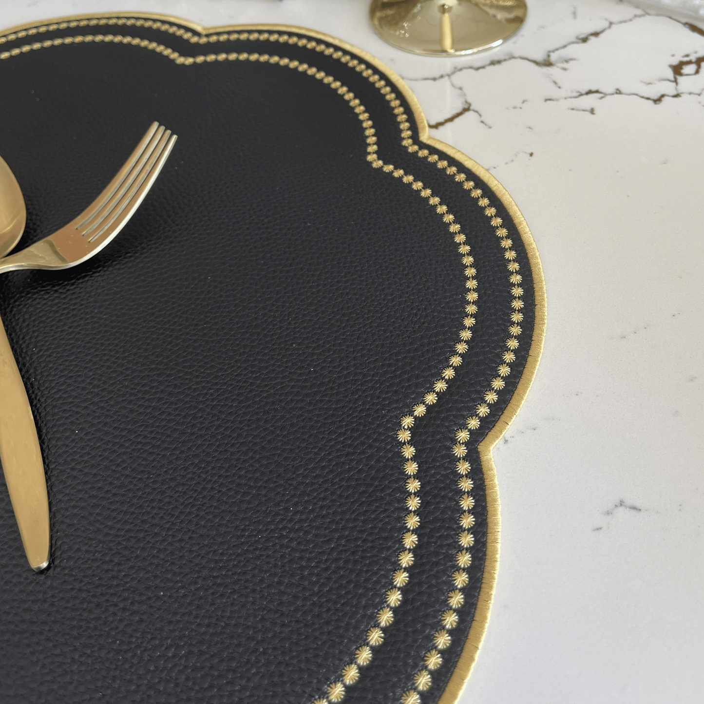 Nurture Black Gold Round Faux Leather Placemat – close-up view showing the intricate embroidery, double-layer stitching, and premium vegan faux leather texture. Exclusively by PNR Decor.