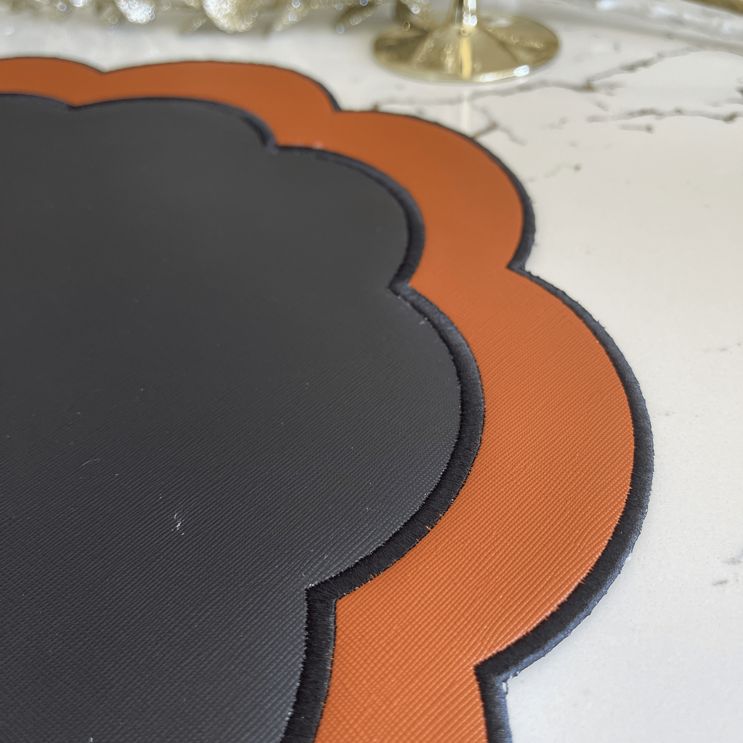 Serenity Black Orange Faux Leather Placemat
– close-up view showing the intricate embroidery, double-layer stitching, and premium vegan faux leather texture. Exclusively by PNR Decor.