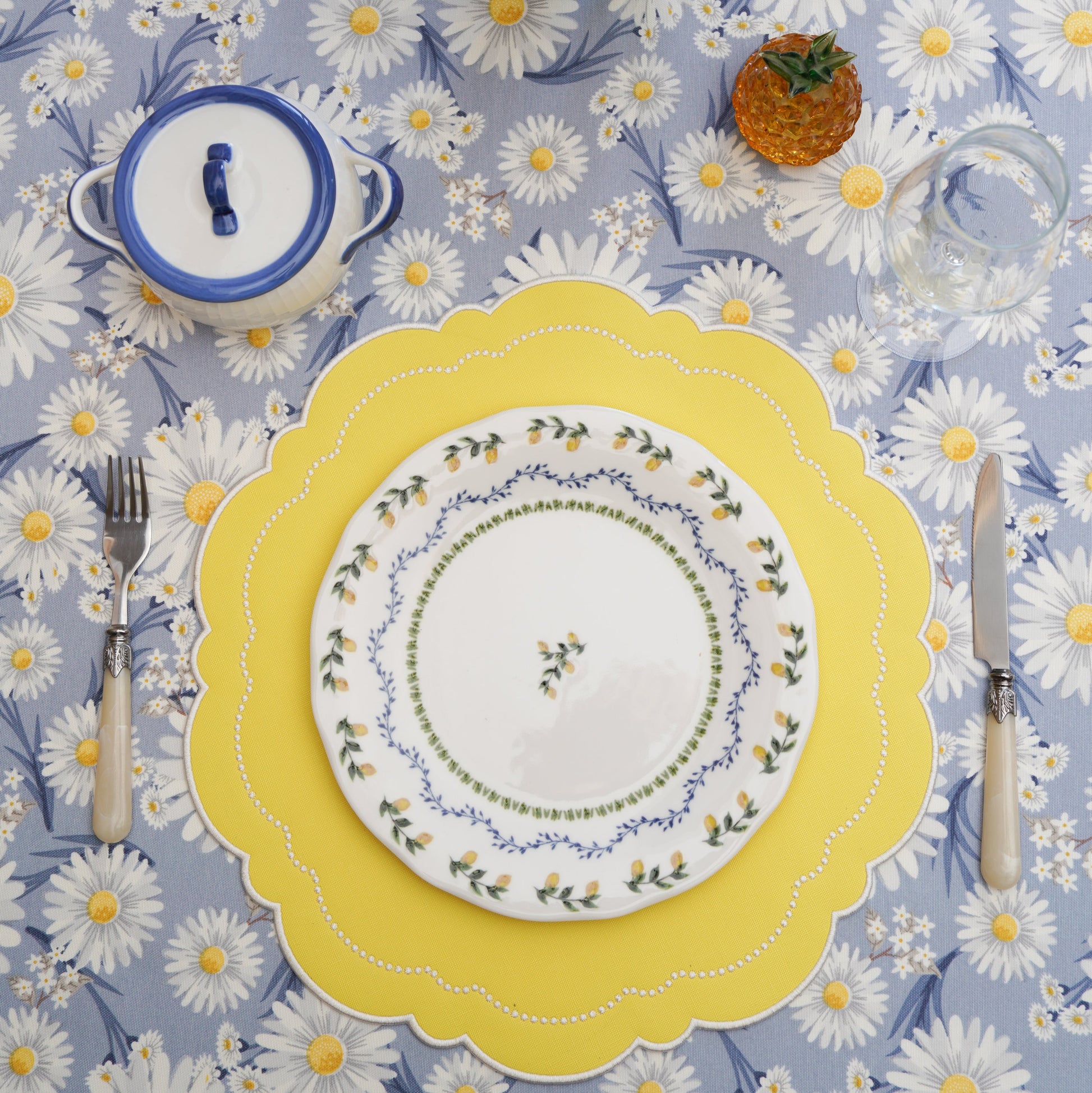Close-up of round vegan leather placemat with refined embroidery and stitched border