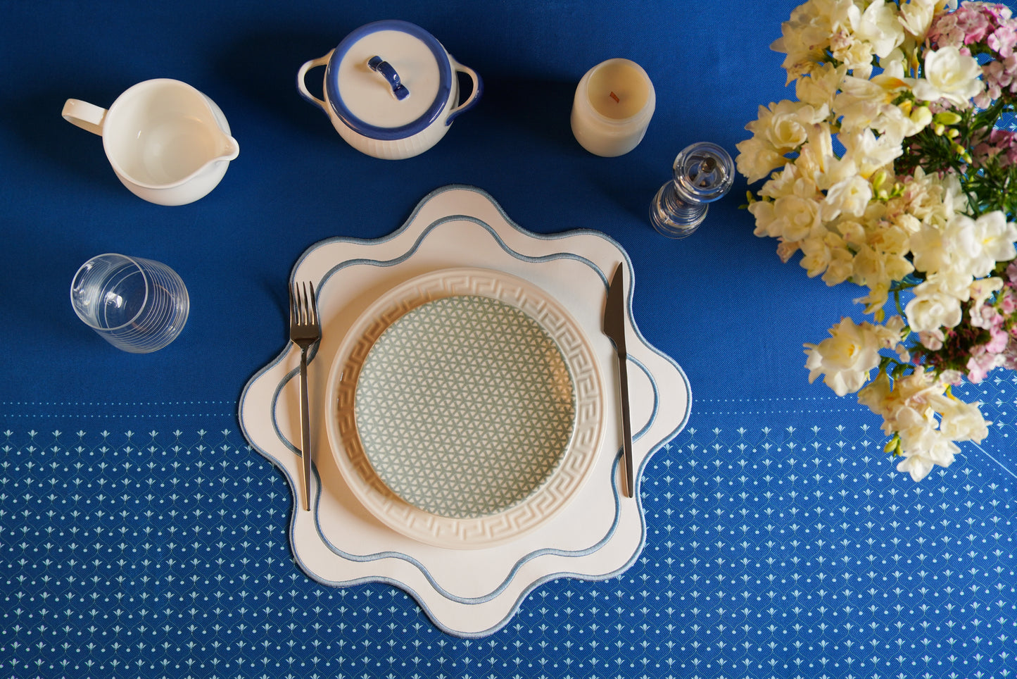 Haven white and blue faux leather placemat with detailed embroidery, ideal for elegant dining and special events
