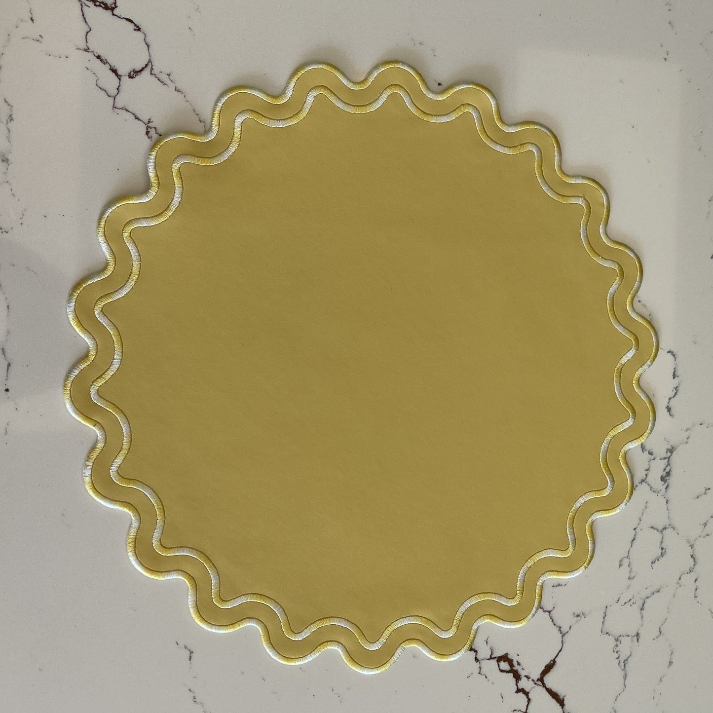 Elysian Yellow Round Faux Leather Placemat – expertly handcrafted from eco-friendly, vegan faux leather with elegant embroidery and double-layered design, stain-resistant and durable.