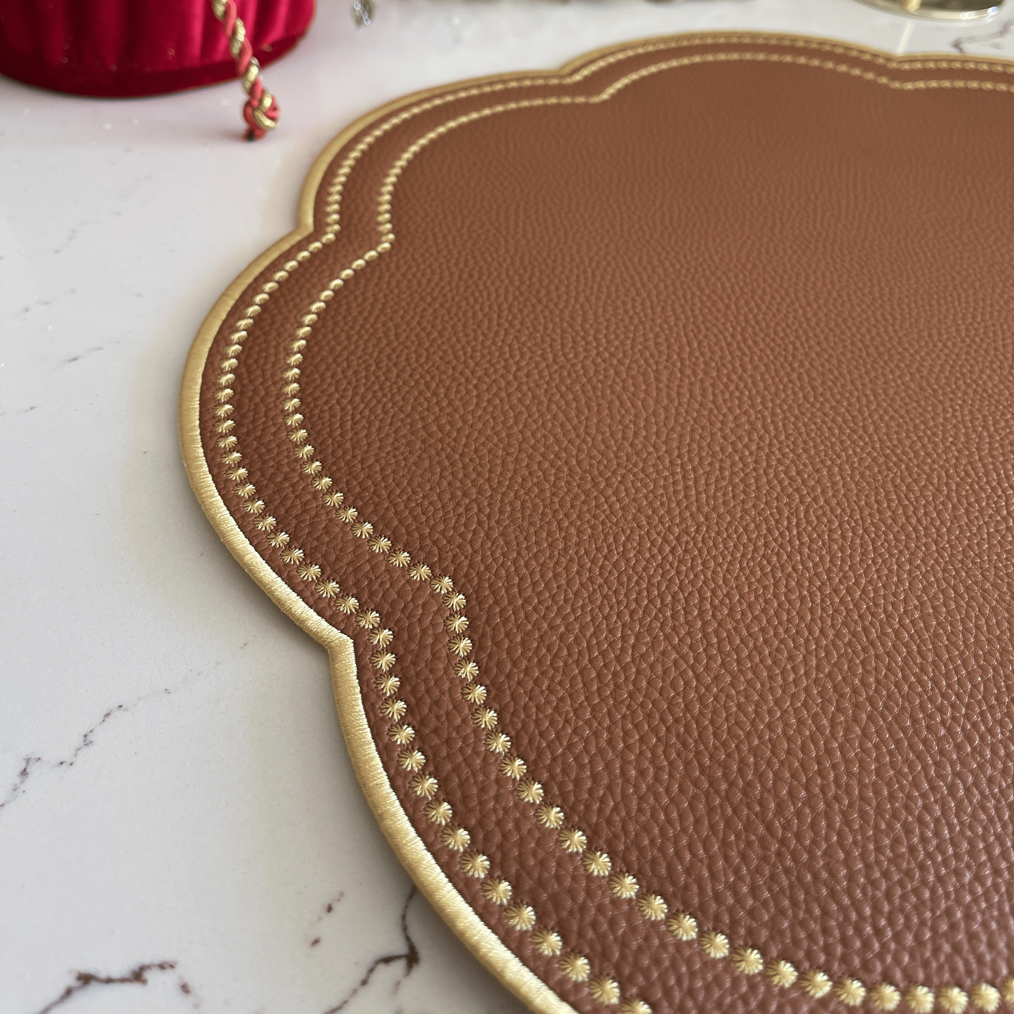 Nurture Brown Gold Round Faux Leather Placemat – close-up view showing the intricate embroidery, double-layer stitching, and premium vegan faux leather texture. Exclusively by PNR Decor.