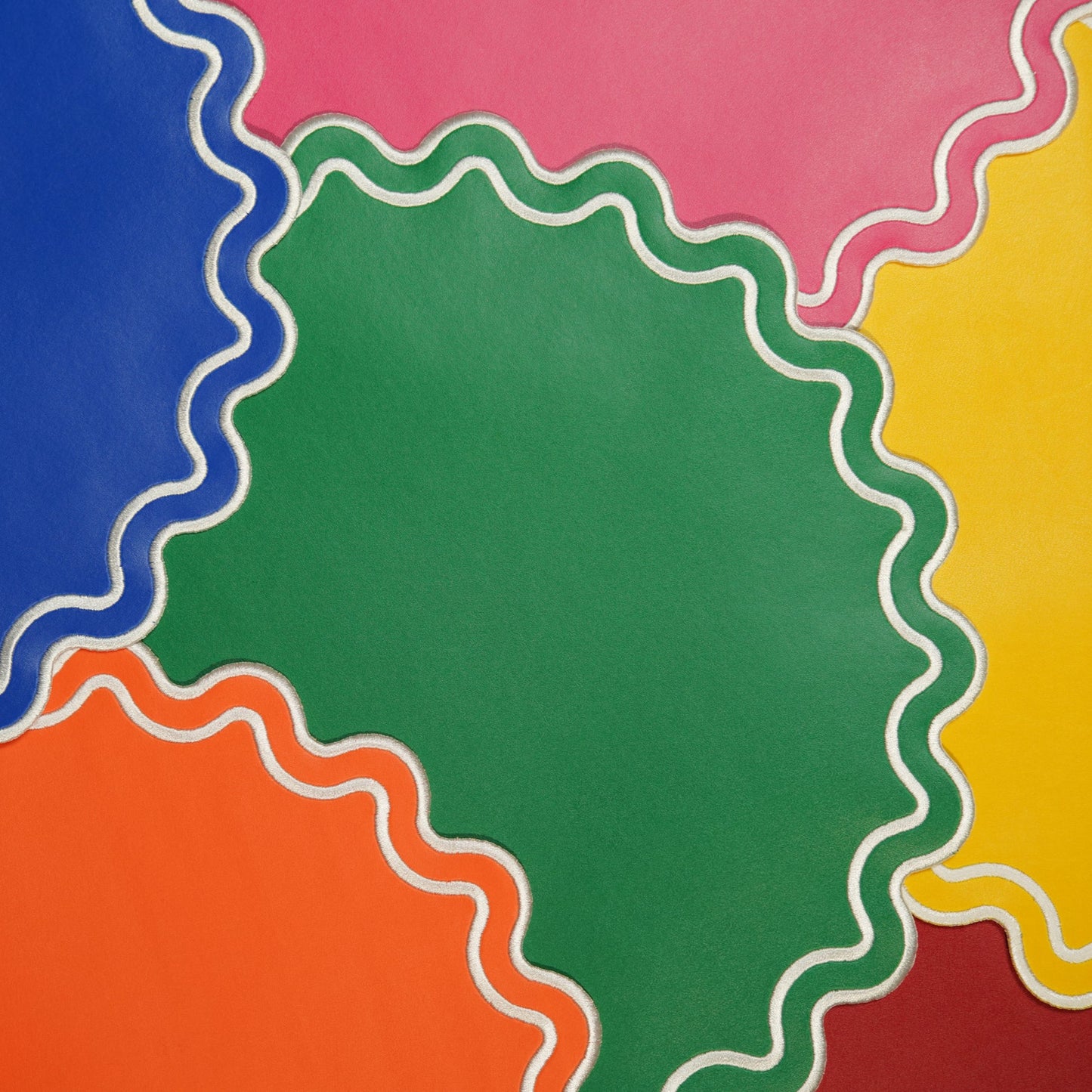 Solace Blue Pink Orange Green Yellow Round Faux Leather Placemat
– close-up view showing the intricate embroidery, many colors, double-layer stitching, and premium vegan faux leather texture. Exclusively by PNR Decor.