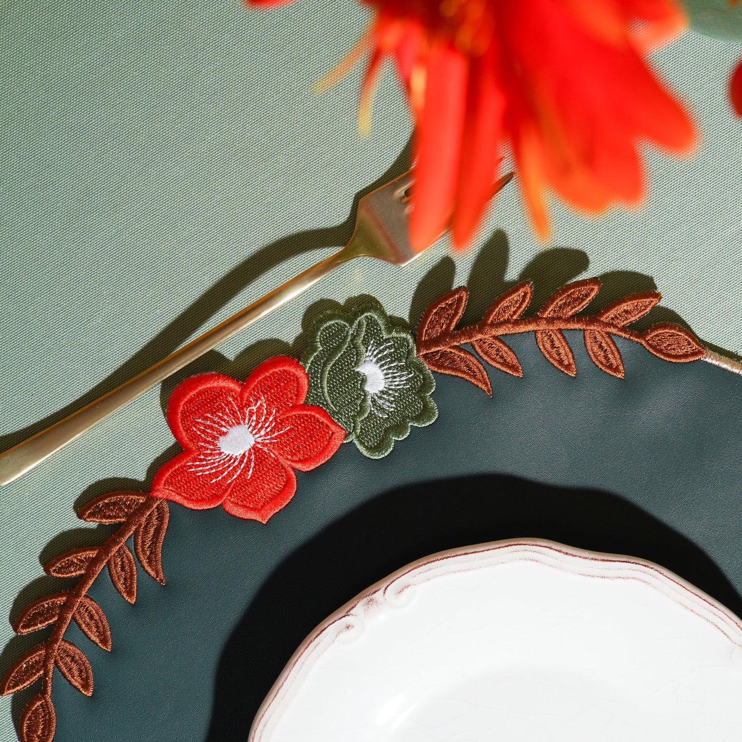 Close-up of sophisticated dark placemat with intricate stitched pattern