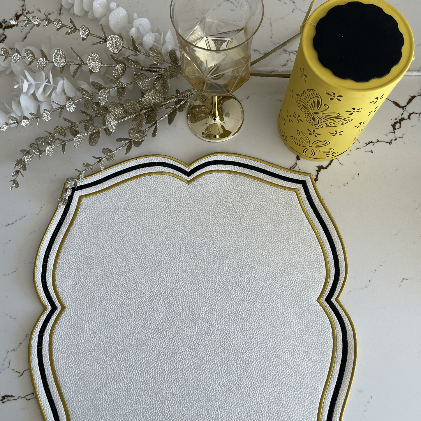 Zeal White Black Gold Square Faux Leather Placemat
– detailed shot highlighting the stain-resistant, handcrafted quality and layered construction of the faux leather surface. Exclusively by PNR Decor.