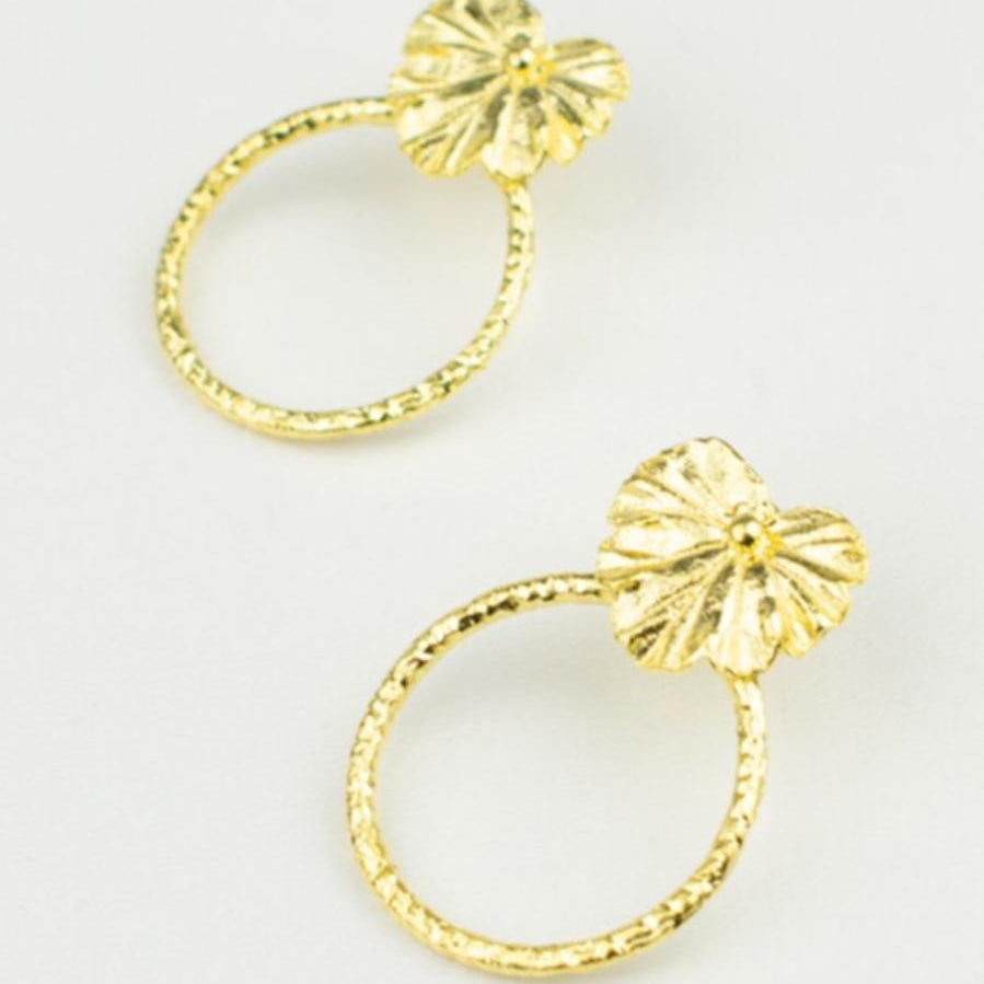 A pair of handcrafted 18K gold-plated 925 sterling silver hoop earrings. Each earring features a detailed casting of a real heart-shaped geranium leaf as the stud, from which a graceful textured hoop dangles. The earrings are 4 cm long and 3 cm wide.