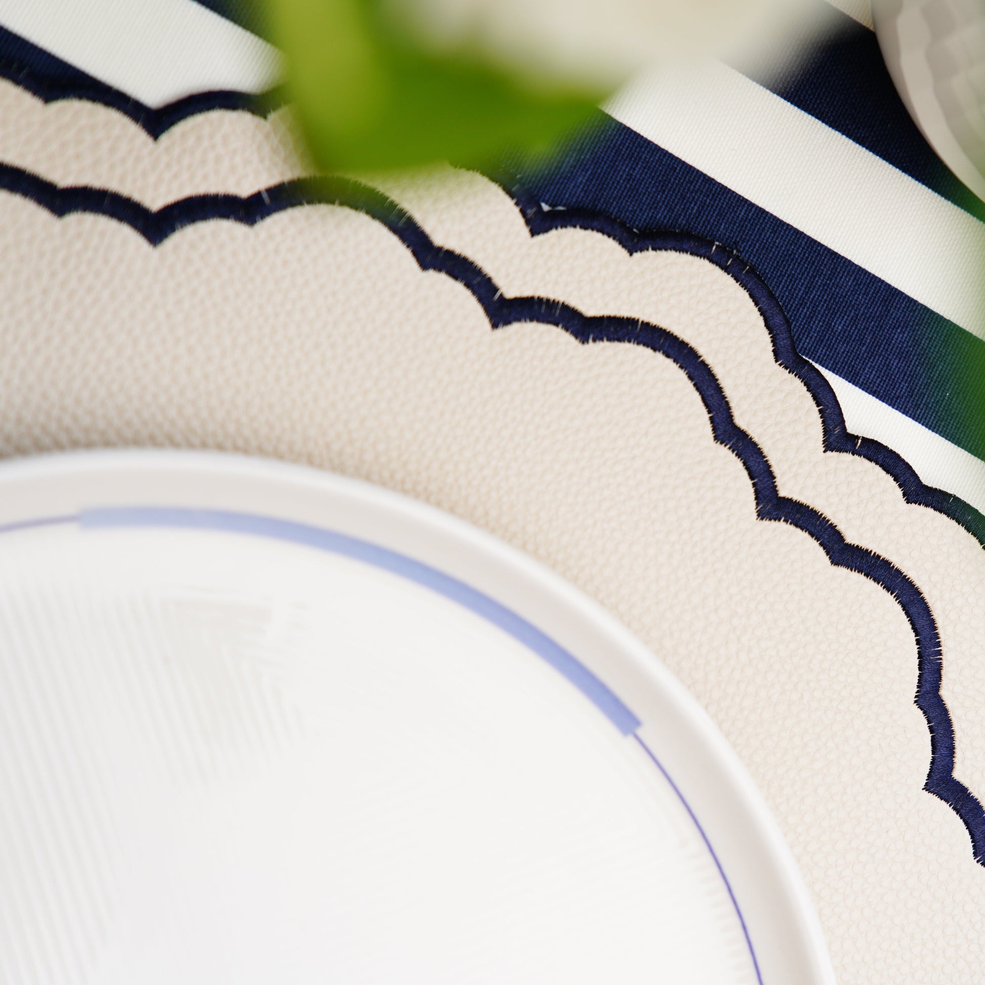 Scarlett White Navy Round Embroidered Faux Leather Placemat – Handcrafted luxury from eco-friendly vegan materials, elegantly embroidered and stain-resistant. Exclusively designed by PNR Decor.
