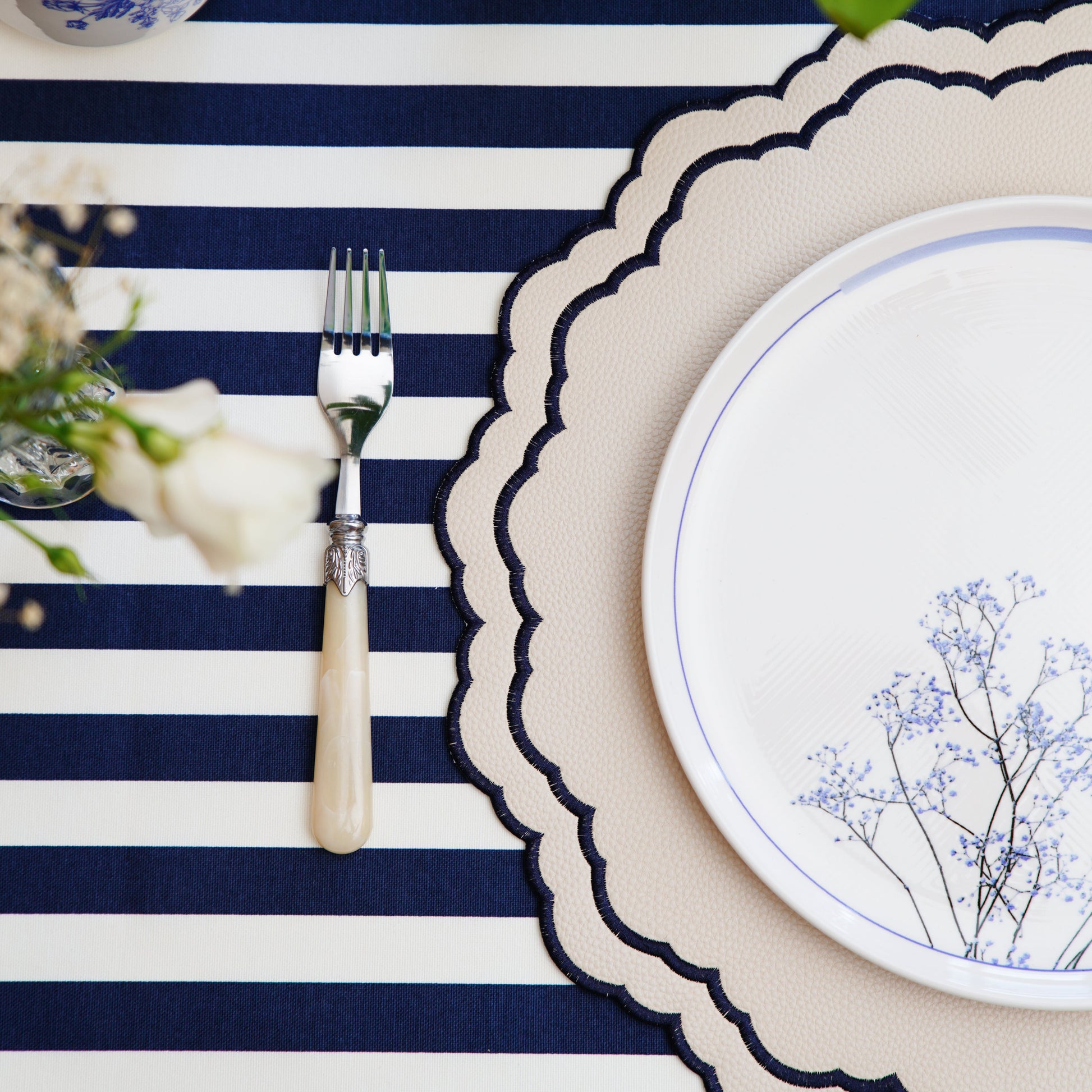 Scarlett White Navy Vegan Faux Leather Placemat – Embellished with refined embroidery, expertly constructed with double-layered, stain-resistant vegan leather. Perfect for special occasions. Exclusively at PNR Decor.