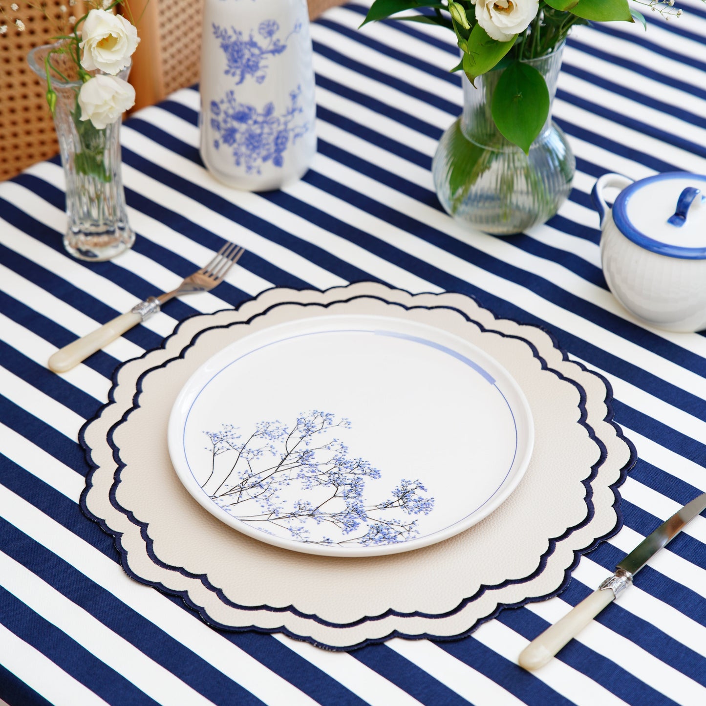 Scarlett White Round Vegan Leather Placemat – Expert craftsmanship combined with elegant navy embroidery, sustainable faux leather, and superior stain-resistant finish. Ideal for upscale dining. Exclusively at PNR Decor.
