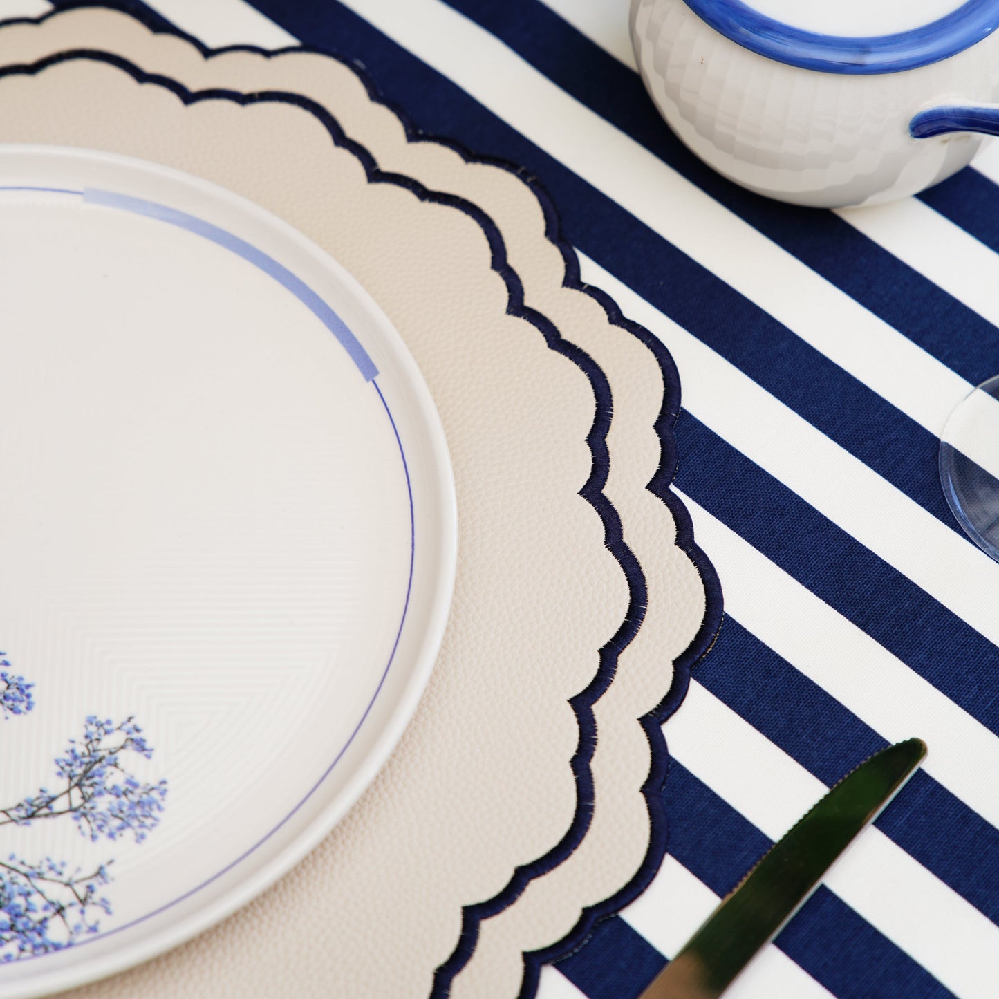 Scarlett White Navy Faux Leather Luxury Placemat – Handmade elegance meets practicality in this beautifully embroidered vegan placemat. Stain-resistant and stylish. Exclusive to PNR Decor.
