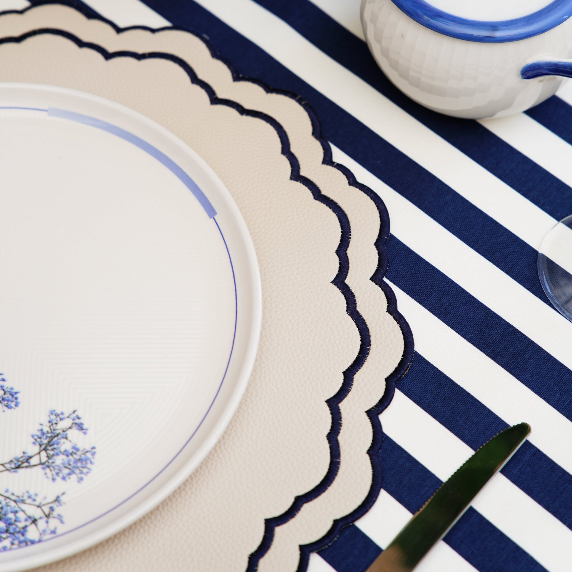 Scarlett White Navy Faux Leather Luxury Placemat – Handmade elegance meets practicality in this beautifully embroidered vegan placemat. Stain-resistant and stylish. Exclusive to PNR Decor.