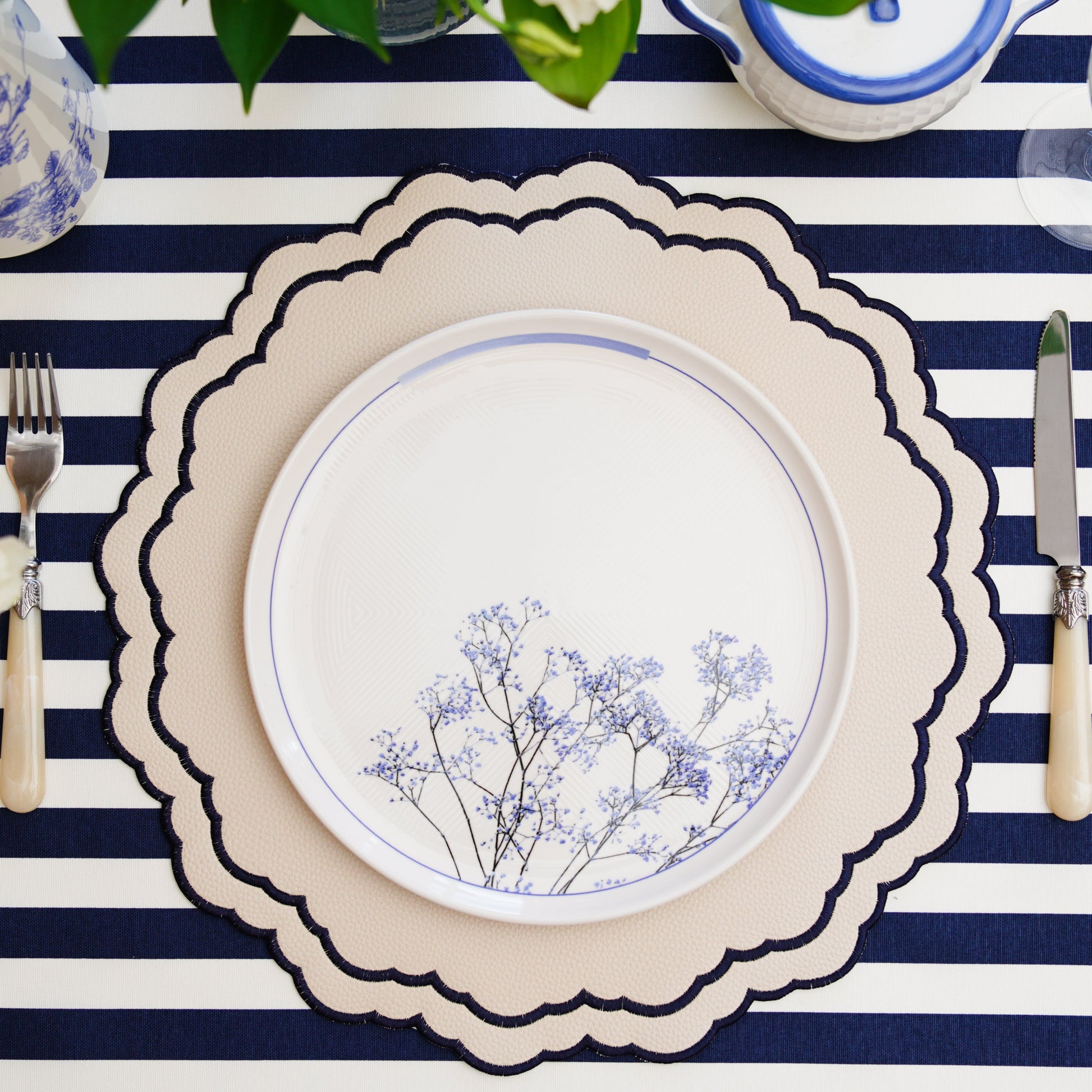 Scarlett White Navy Faux Leather Placemat – The epitome of elegance and functionality, handcrafted with cruelty-free materials, featuring refined navy embroidery and a double-layered stain-resistant finish. A PNR Decor exclusive.