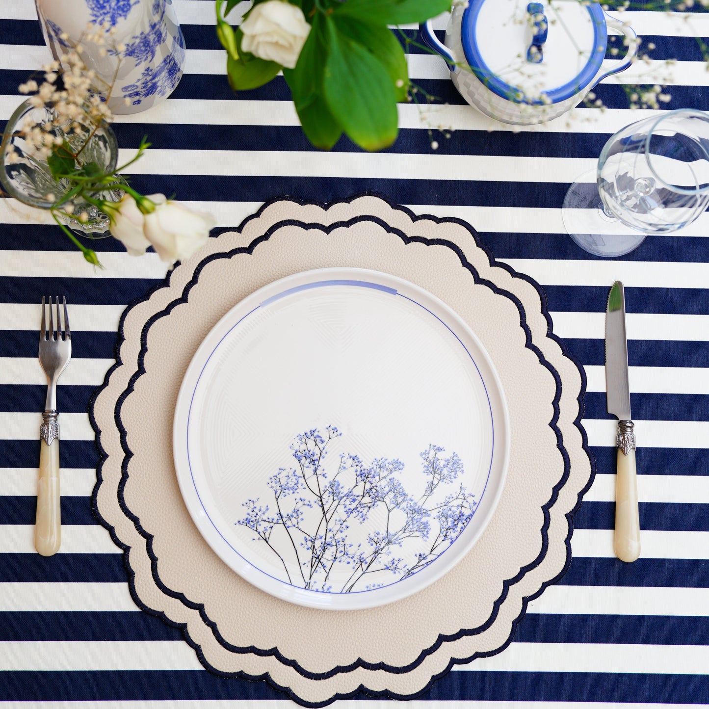 Scarlett White Round Faux Leather Placemat – Luxuriously handcrafted with vegan faux leather, featuring intricate navy embroidery, double-layered durability, and an easy-to-clean, stain-resistant surface. Exclusively designed by PNR Decor.