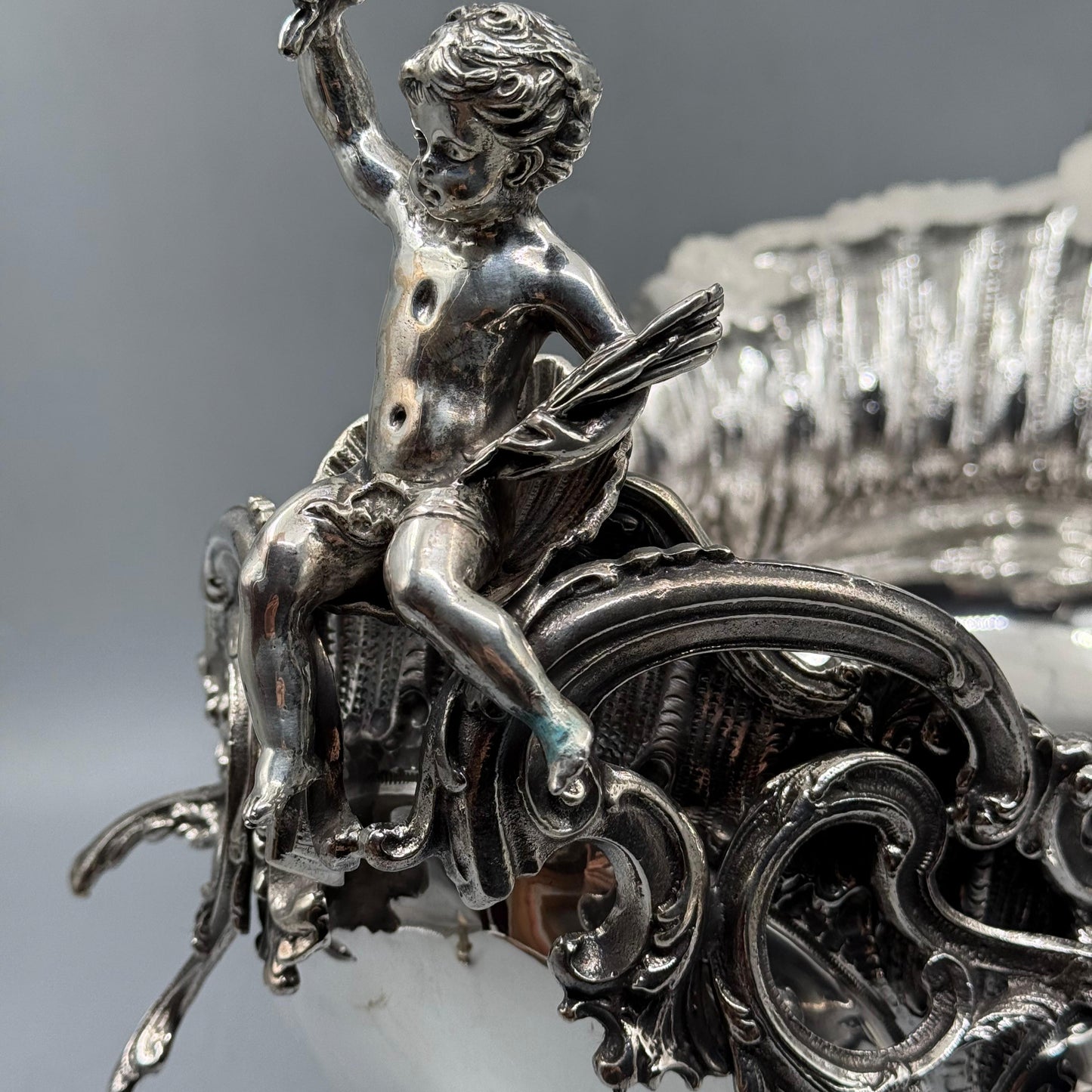 Close-up of detailed silver cherub figurine on Rococo gondola centerpiece