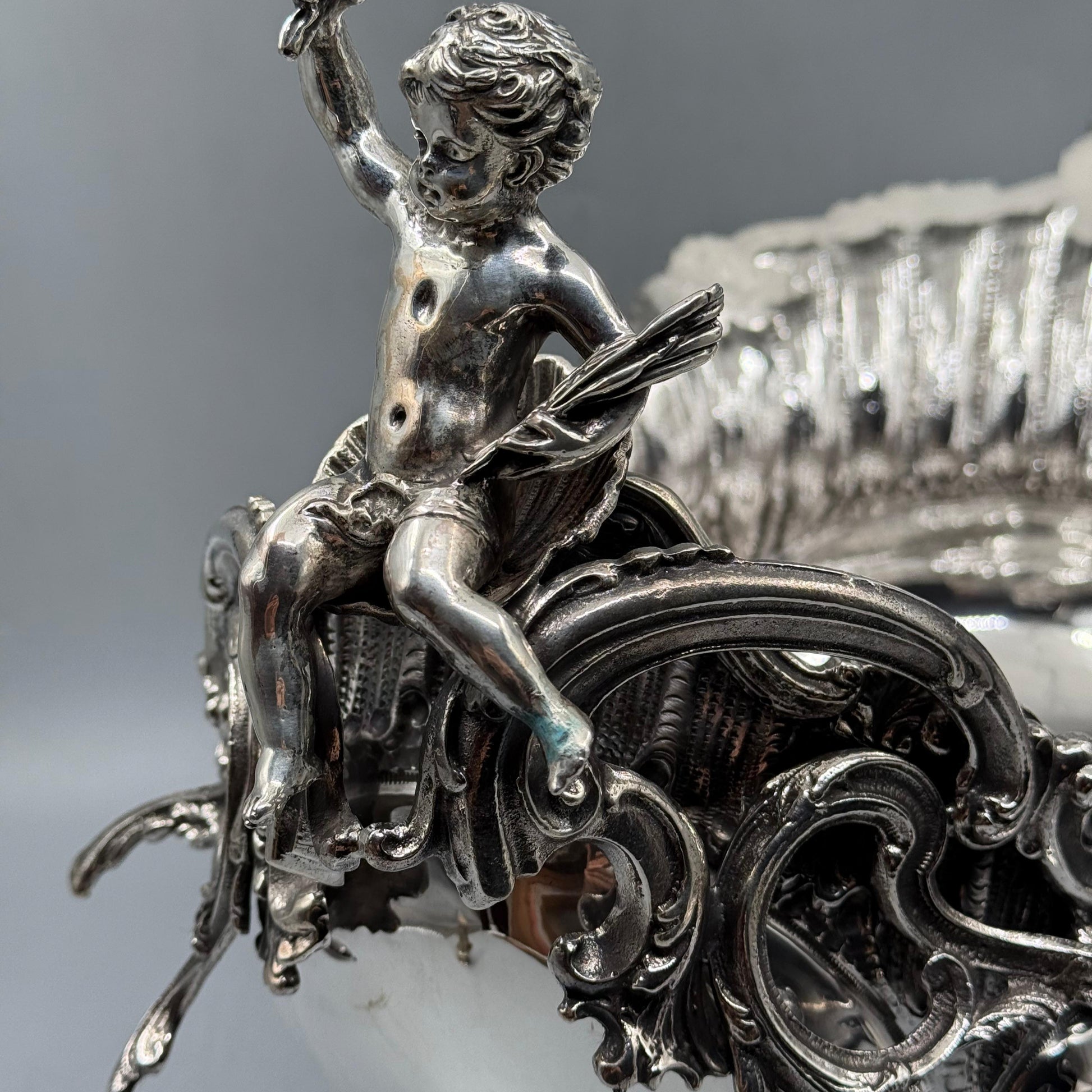 Close-up of detailed silver cherub figurine on Rococo gondola centerpiece