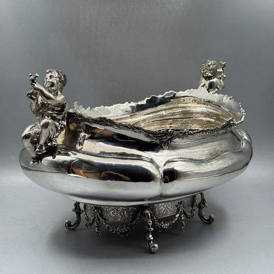 Side view of antique silver gondola bowl with cherub figures