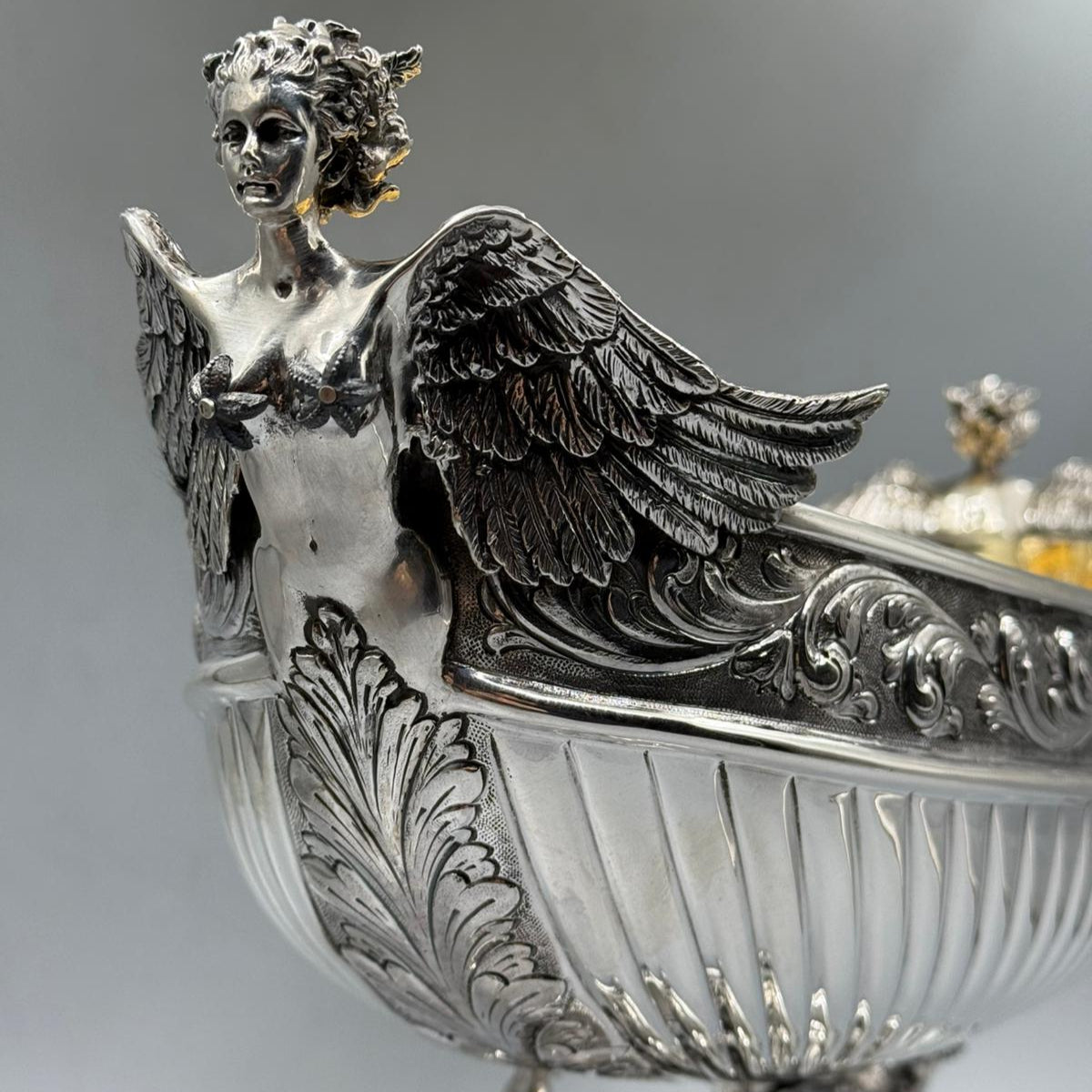 Close-up of detailed Hercules and winged figure on antique silver gondola centerpiece