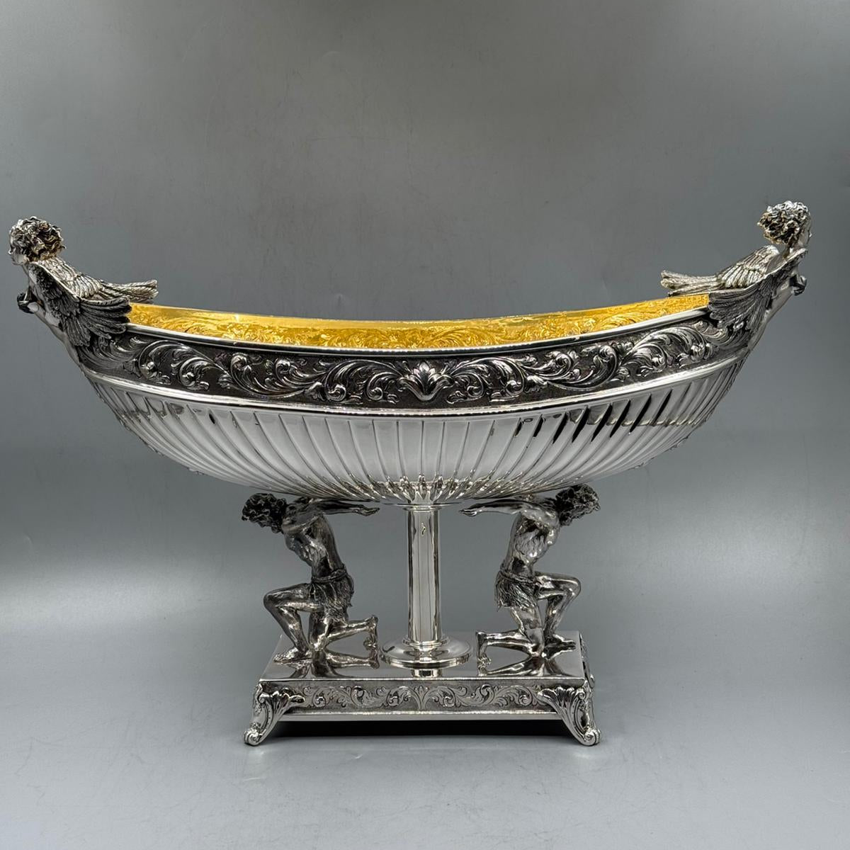 Full side view of antique silver Hercules gondola centerpiece with mythological design