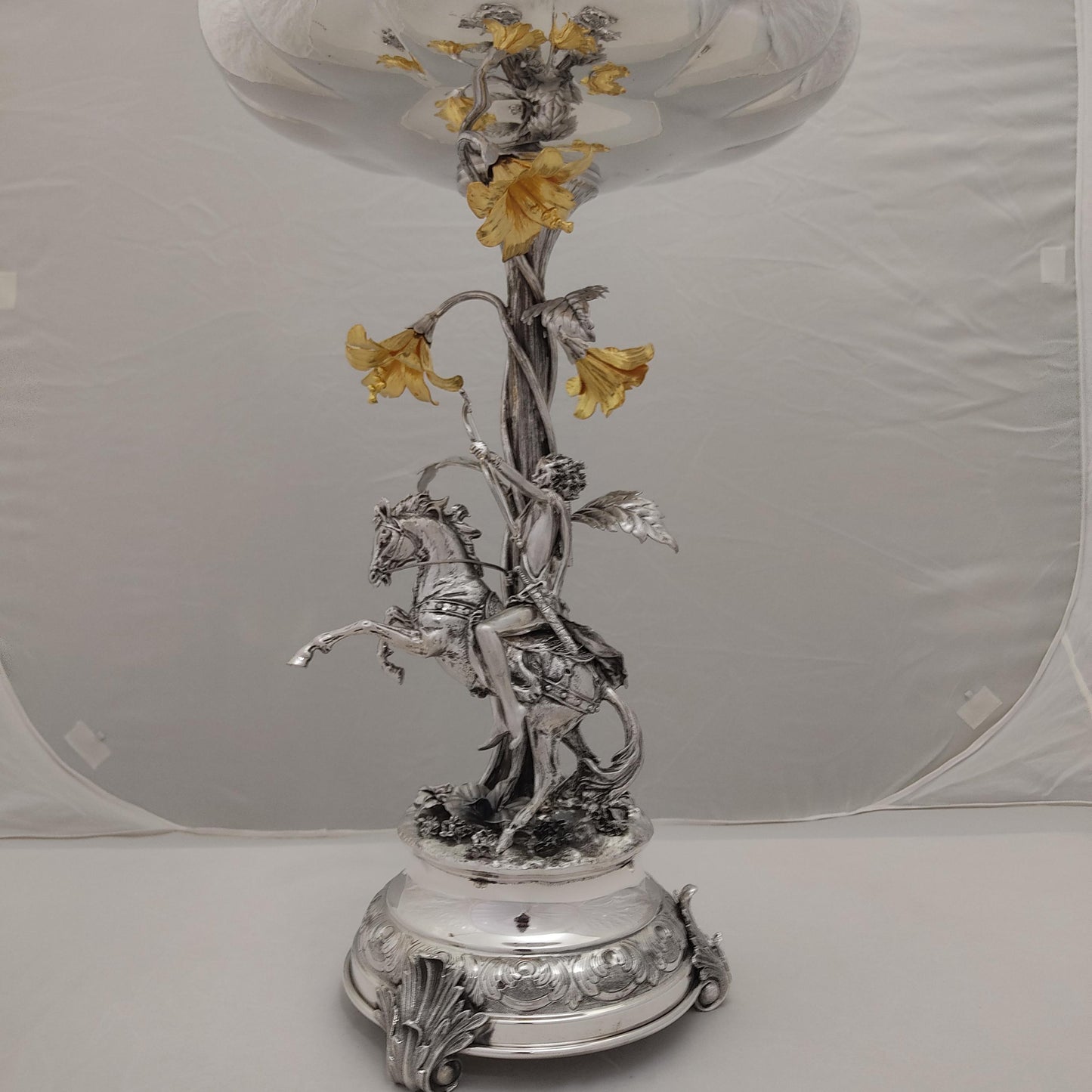 Full view of antique silver centerpiece with horse rider and gilded floral bowl