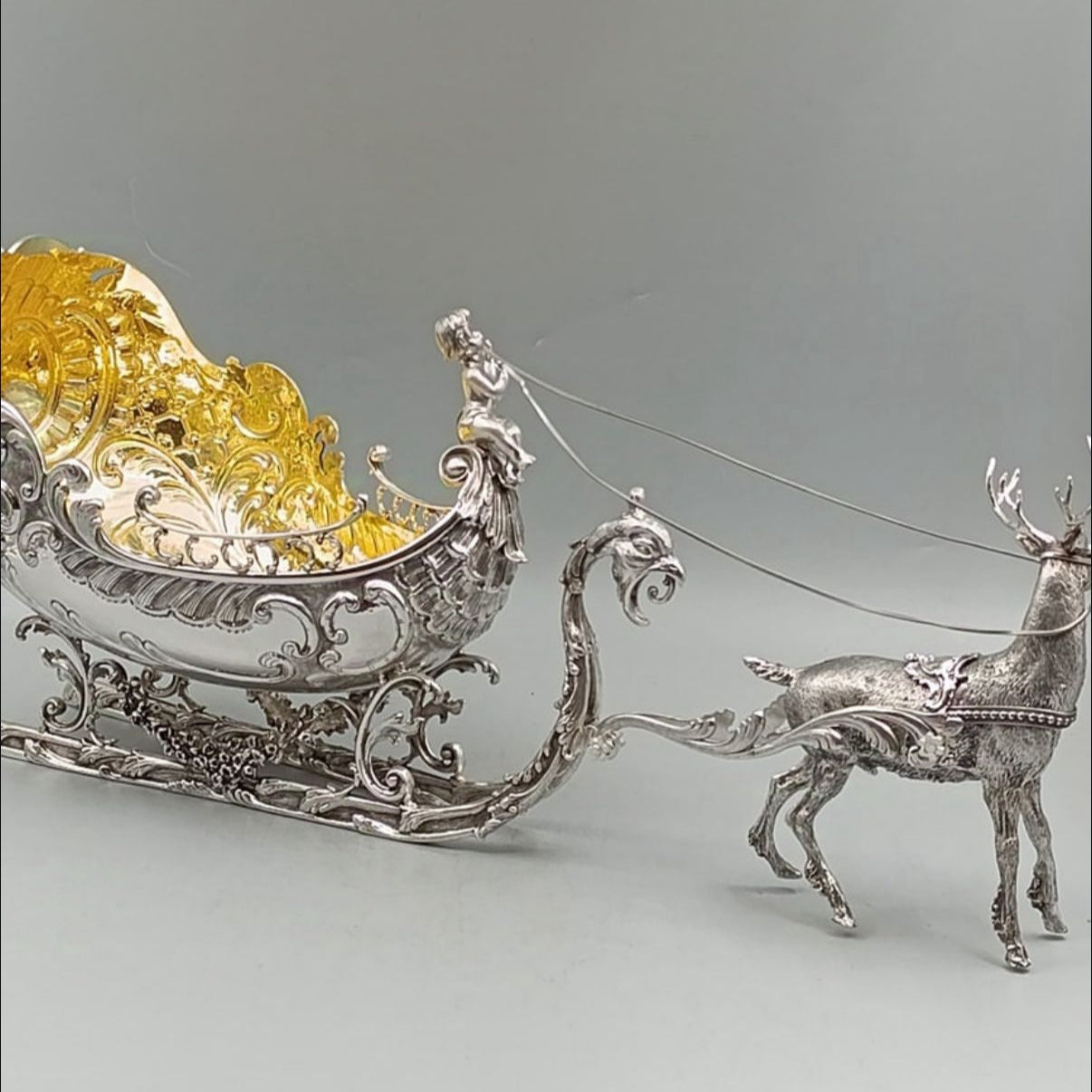Full view of antique silver reindeer sleigh centerpiece with gilded interior