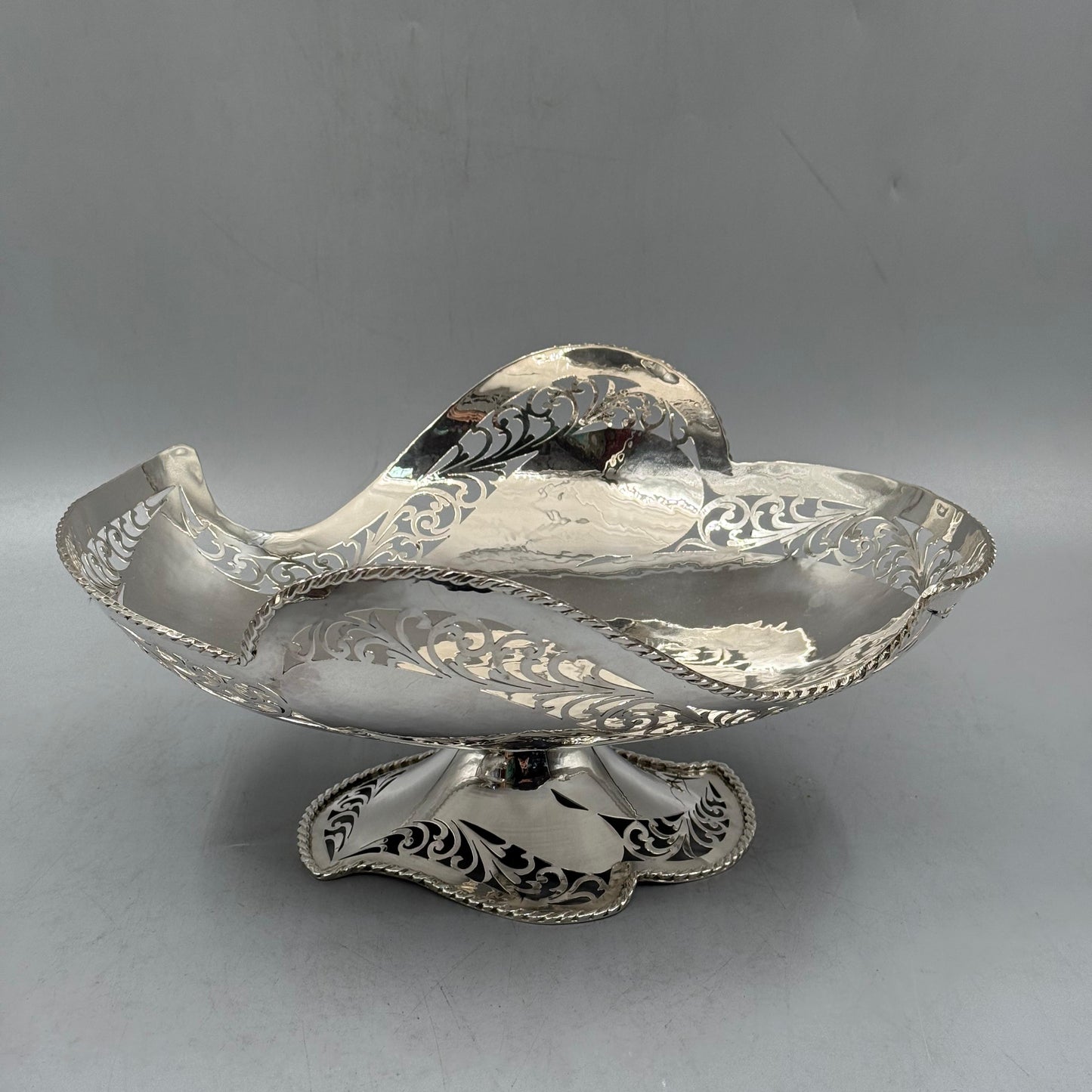 Side view of antique silver pierced boat shaped bowl with rope rim by PNR Decor ship from USA