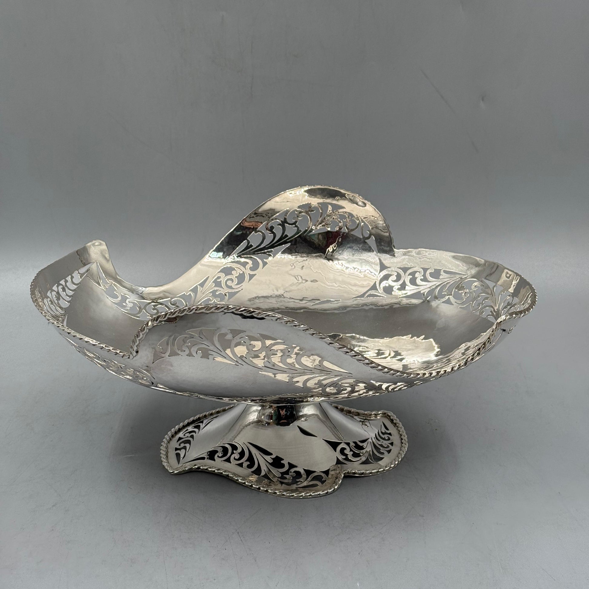 Side view of antique silver pierced boat shaped bowl with rope rim by PNR Decor ship from USA