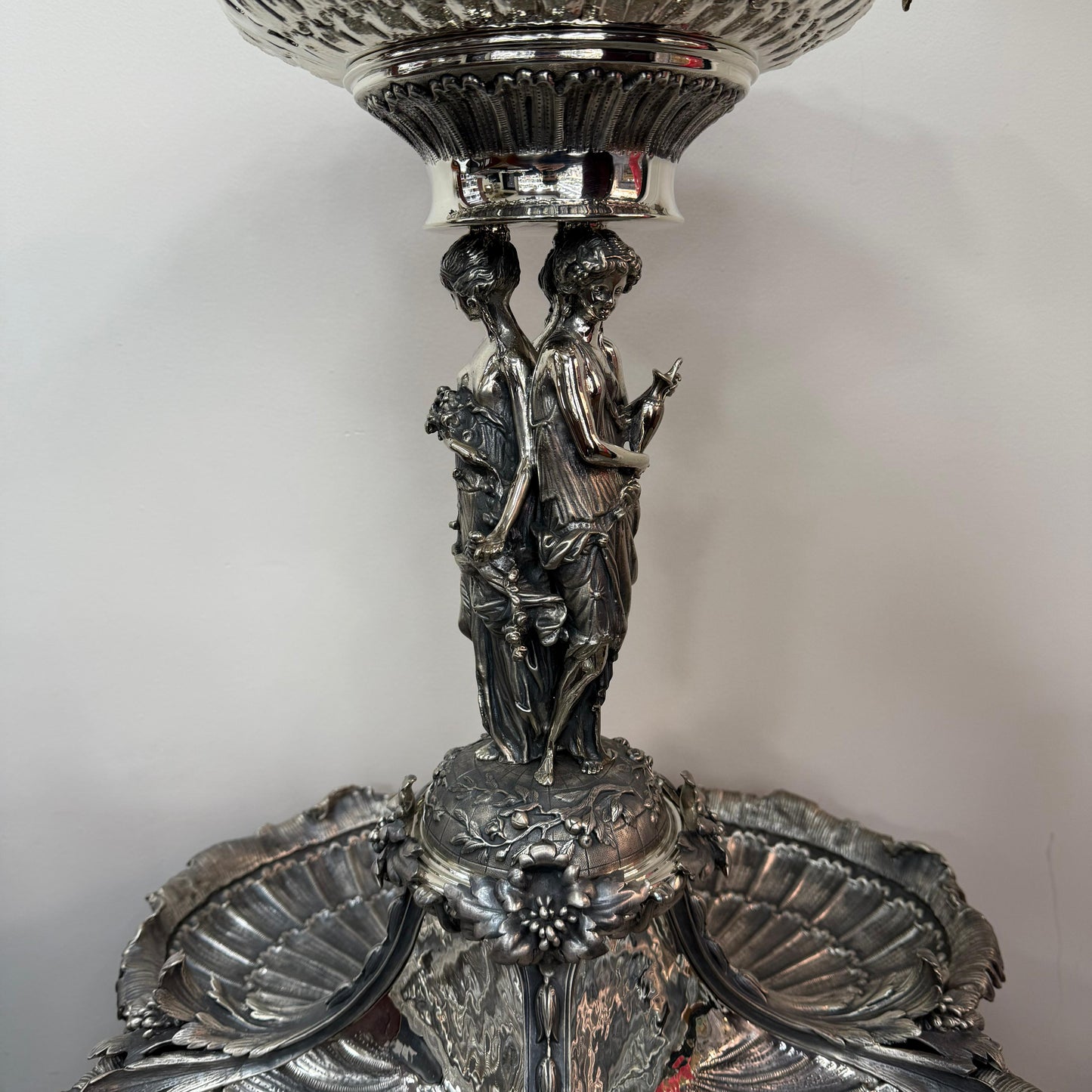 Close-up of classical female figures on antique silver centerpiece