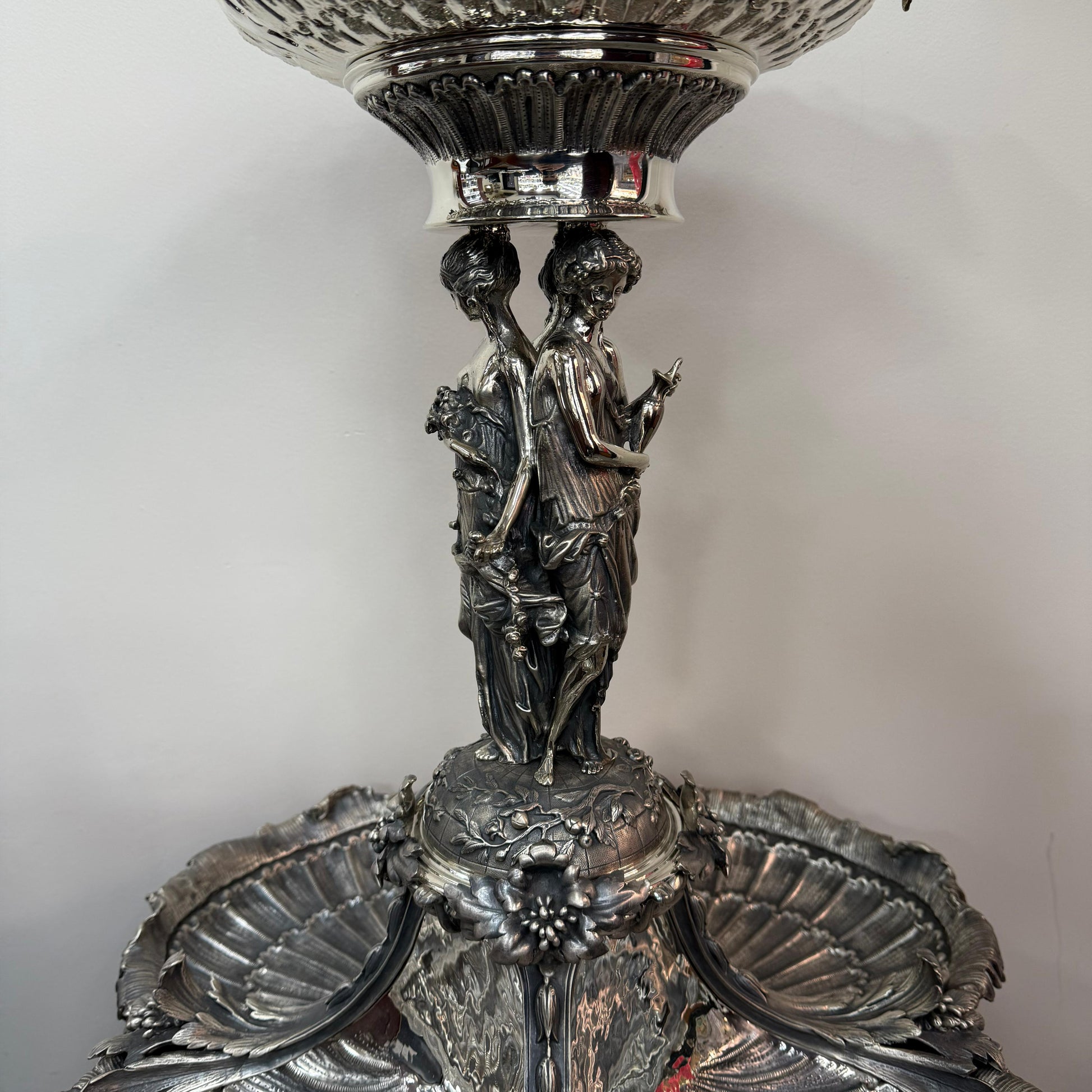 Close-up of classical female figures on antique silver centerpiece