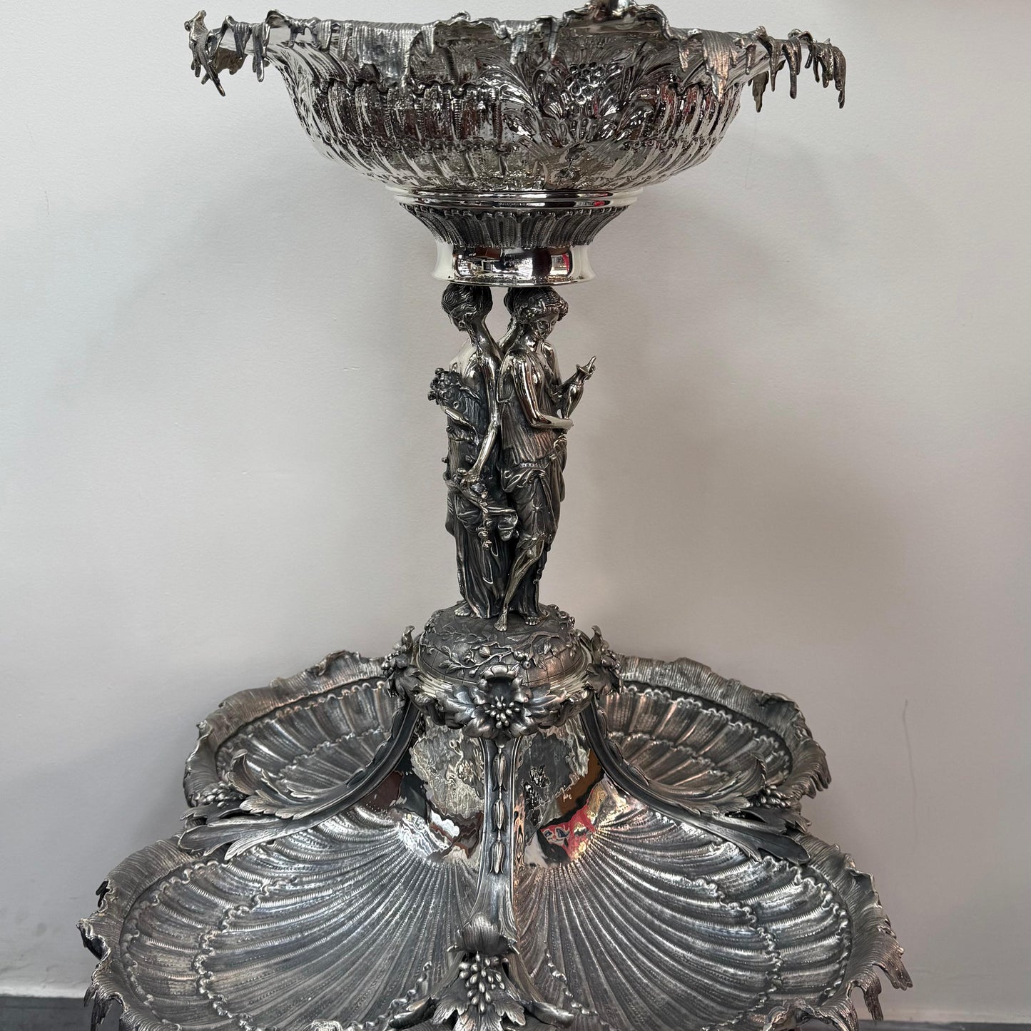Antique silver centerpiece with shell form trays and classical female figures, front view