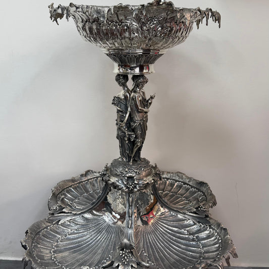 Antique silver centerpiece with shell form trays and classical female figures, front view