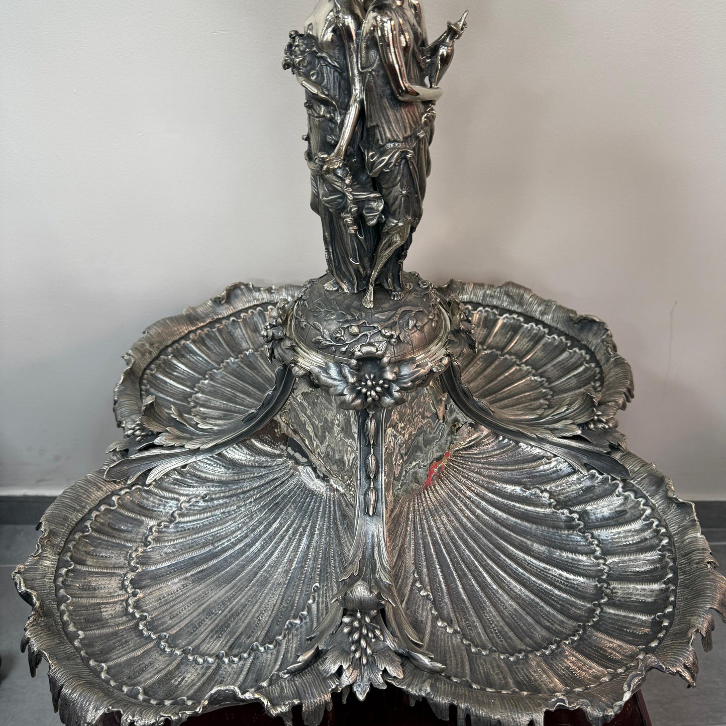 Detailed view of lower shell trays on antique silver centerpiece