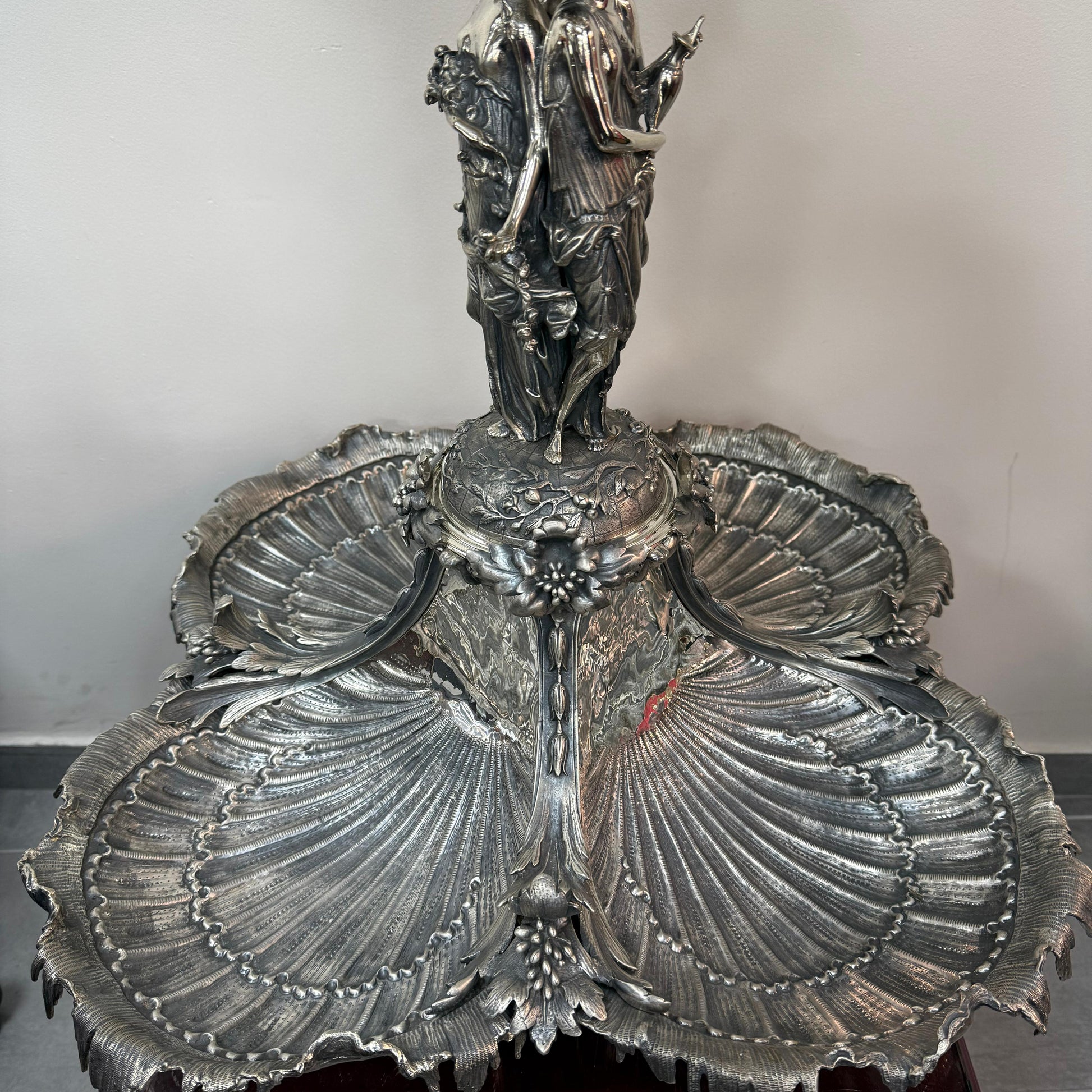 Detailed view of lower shell trays on antique silver centerpiece