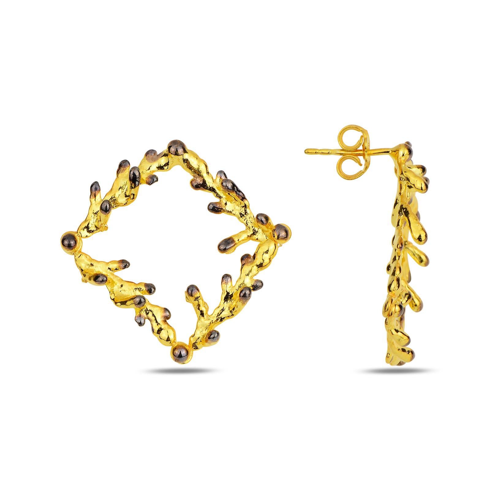 Artisan-made woodland jewelry showing two statement square stud earrings cast from real pine branches. The unique contrast between the radiant gold and dark tips showcases premium craftsmanship.