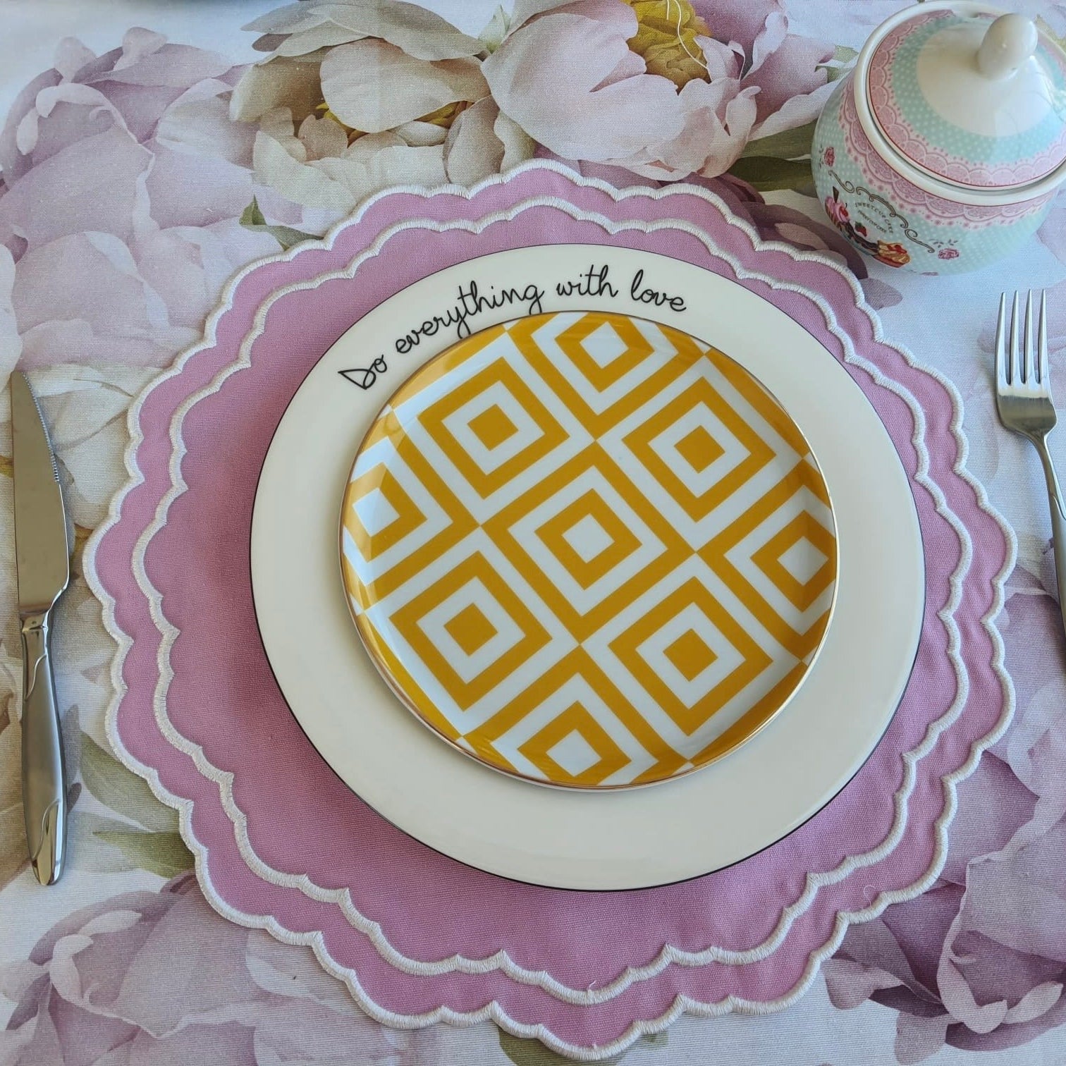 Blush and lilac flower print table linen detail highlighting the delicate petals and subtle fabric texture
