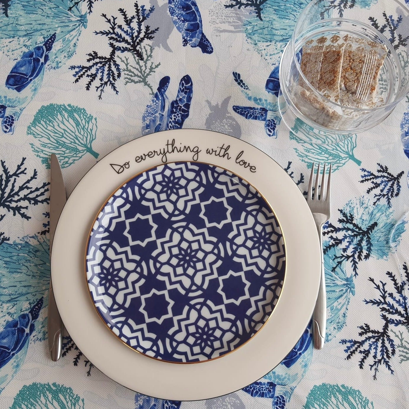 Top view of an ocean-themed table linen featuring sea turtles and coral patterns in navy and aqua shades
