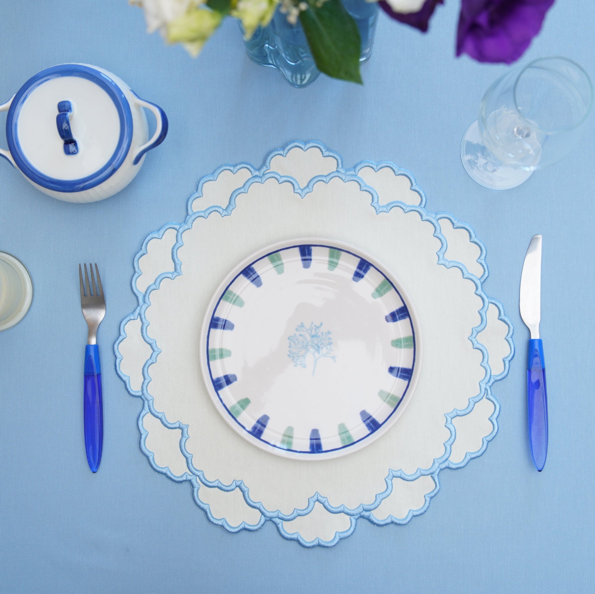A refined tabletop design featuring a delicately shaped placemat