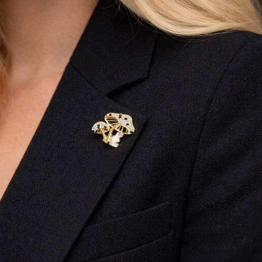 Close up of whimsical gold tone mushroom brooch with crystals and white enamel bunny rabbit on black coat by PNR Decor ship from USA