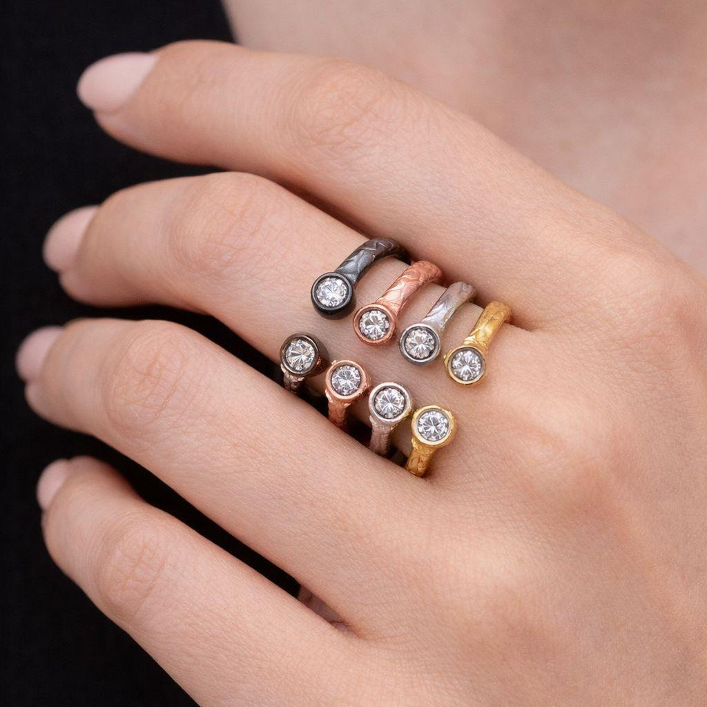 Minimalist and elegant, these artisan-made 999 silver adjustable rings showcase a striking two-tone aesthetic with mixed metal finishes and sparkling accents.