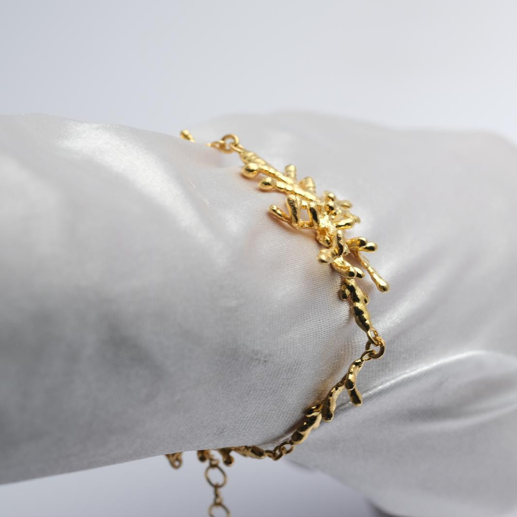 A stunning, nature-inspired statement bracelet crafted from authentic 925 sterling silver with a rich gold finish, perfect for a unique botanical style.