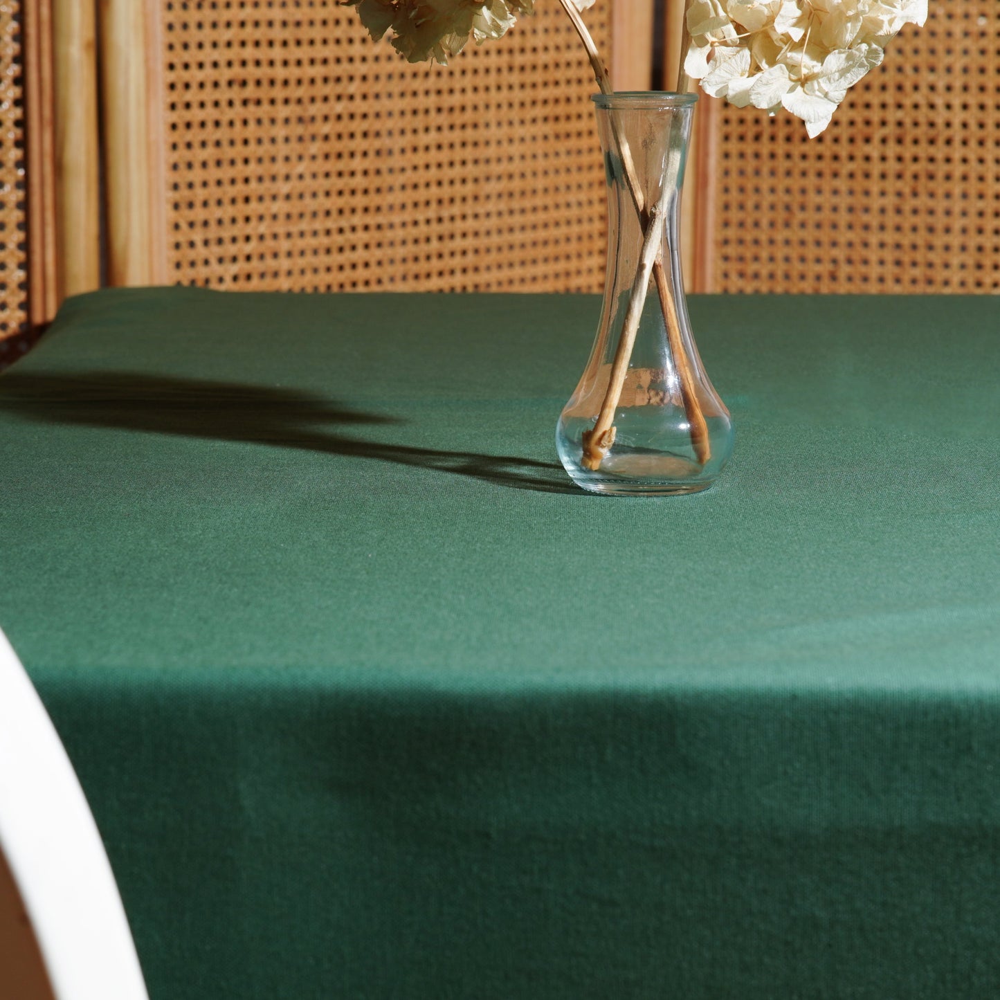 Close-up of the dark green tablecloth showing a smooth, solid finish with subtle fabric texture