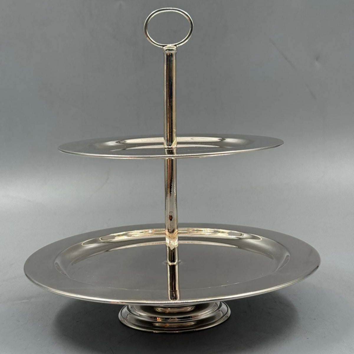 Classic double tier silver cake stand with central handle for serving sweets and fruits