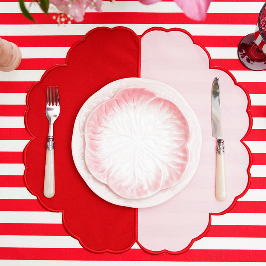 Scalloped fabric placemat arranged on a neatly styled table