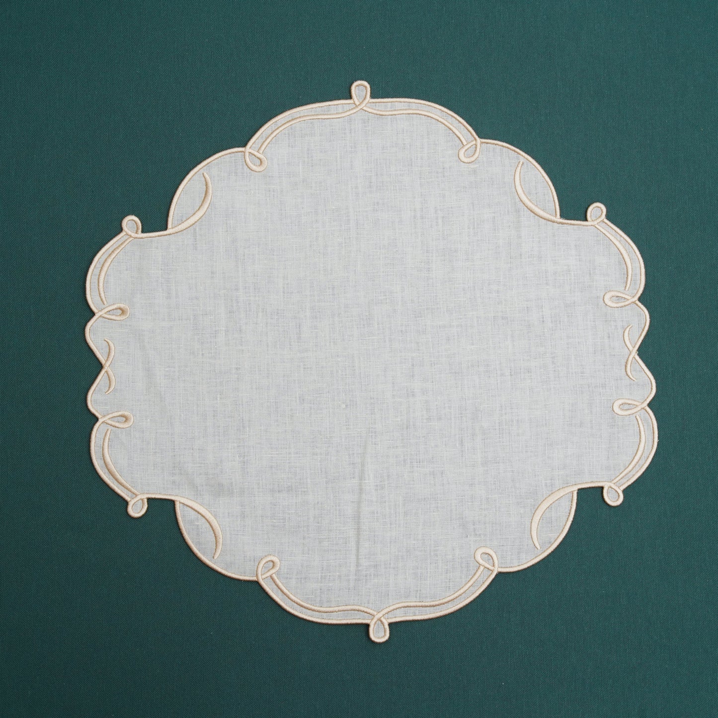 Ivory placemat with golden edges placed on a decorative dining table