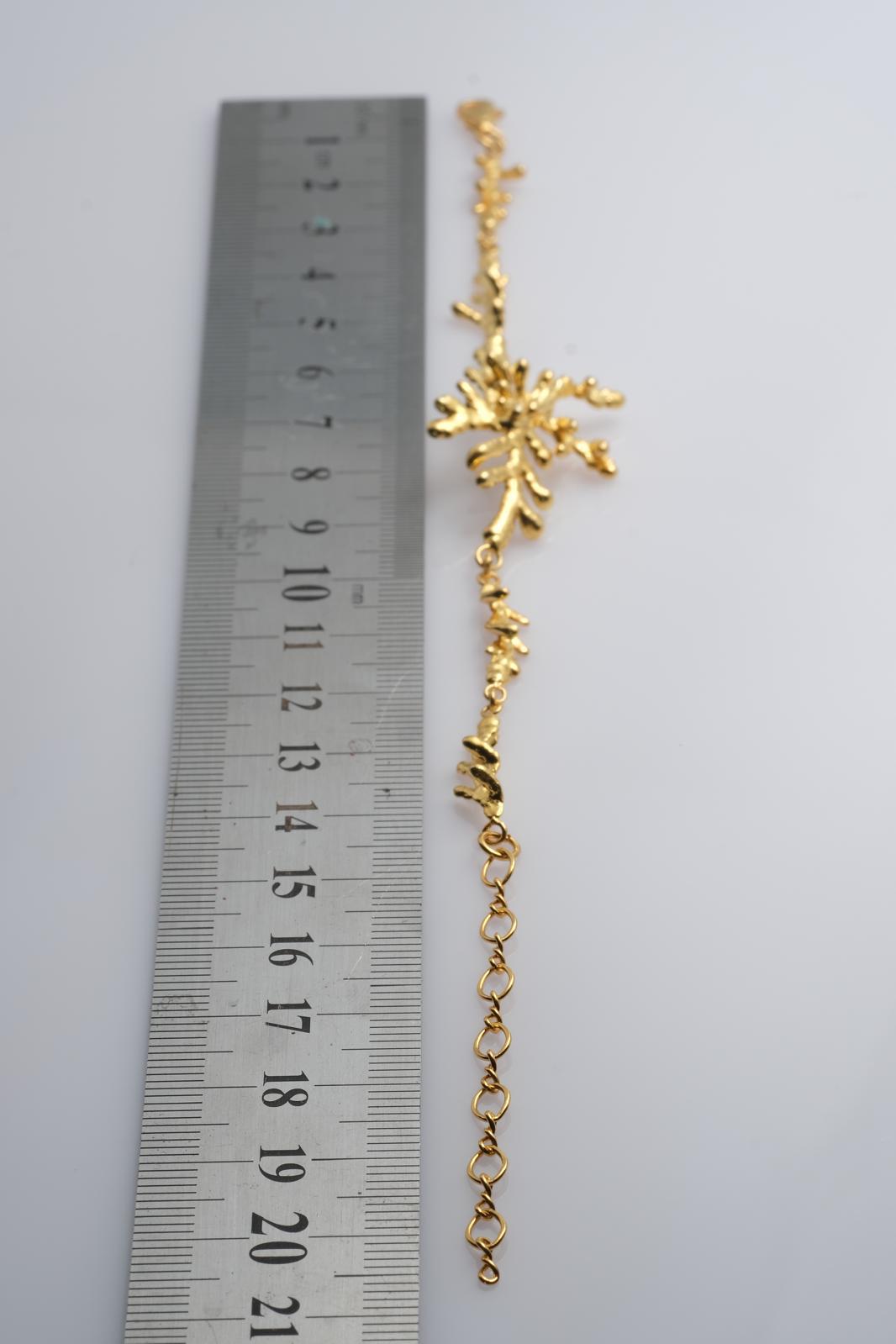The 18K gold-plated pine leaf bracelet displayed elegantly, highlighting the premium craftsmanship and the beautiful 8-gram solid silver base.