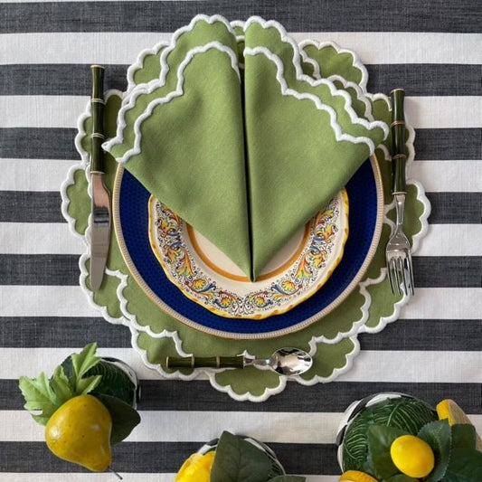 Luxury spring table linens featuring the green scalloped placemat set with elegant cloth napkins