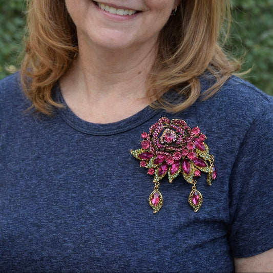 Model wearing vintage style fuchsia crystal rose brooch with dangle drops on blue top by PNR Decor ship from USA